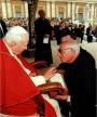 Fr. Maximilian Mizzi receiving a blessing from Pope on the “ Sacred Stone ” .